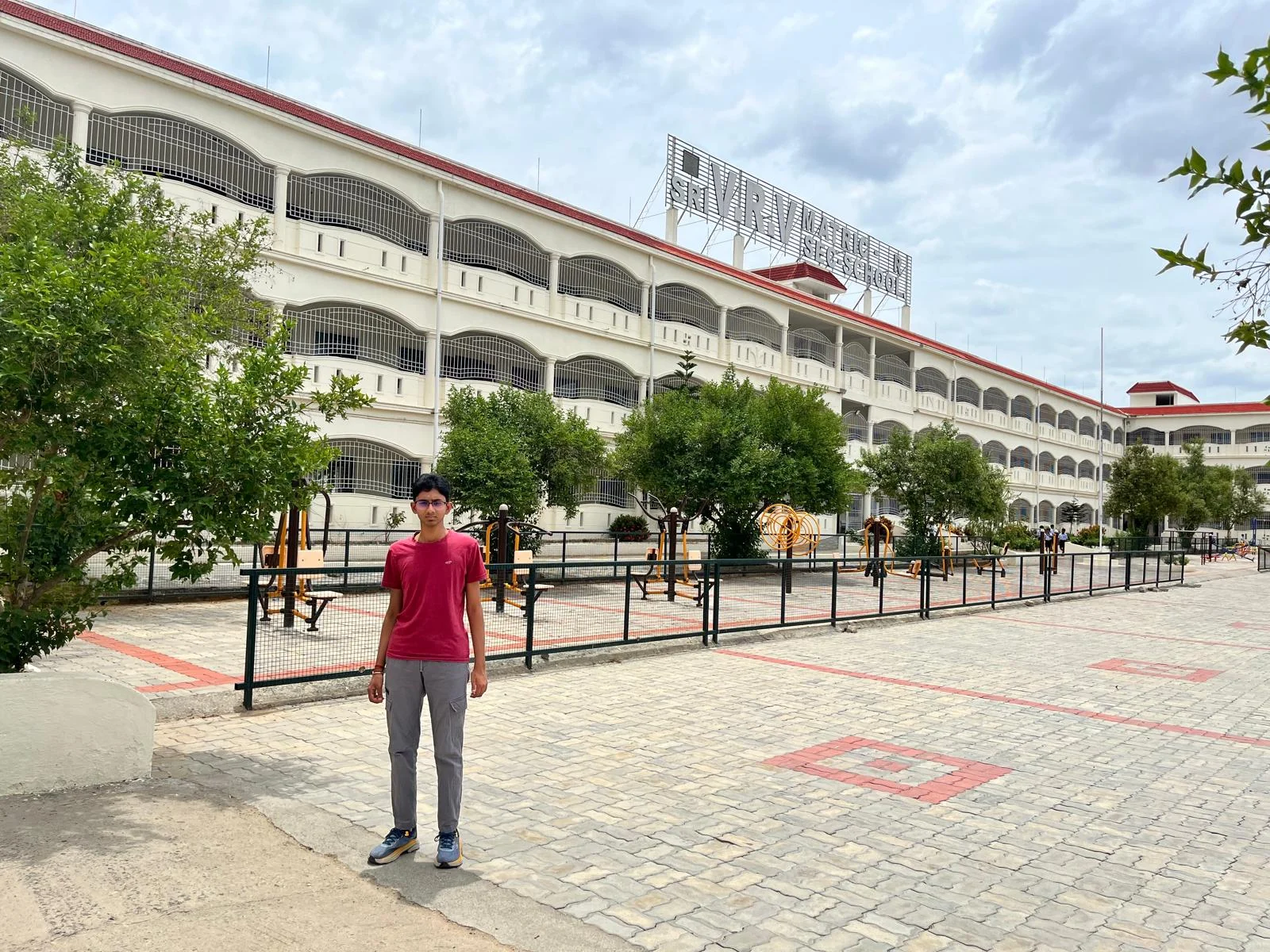 Outside the school building during the summer 2025 visit.